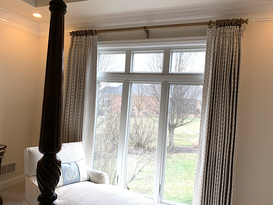 Full-length draperies framing a bedroom window